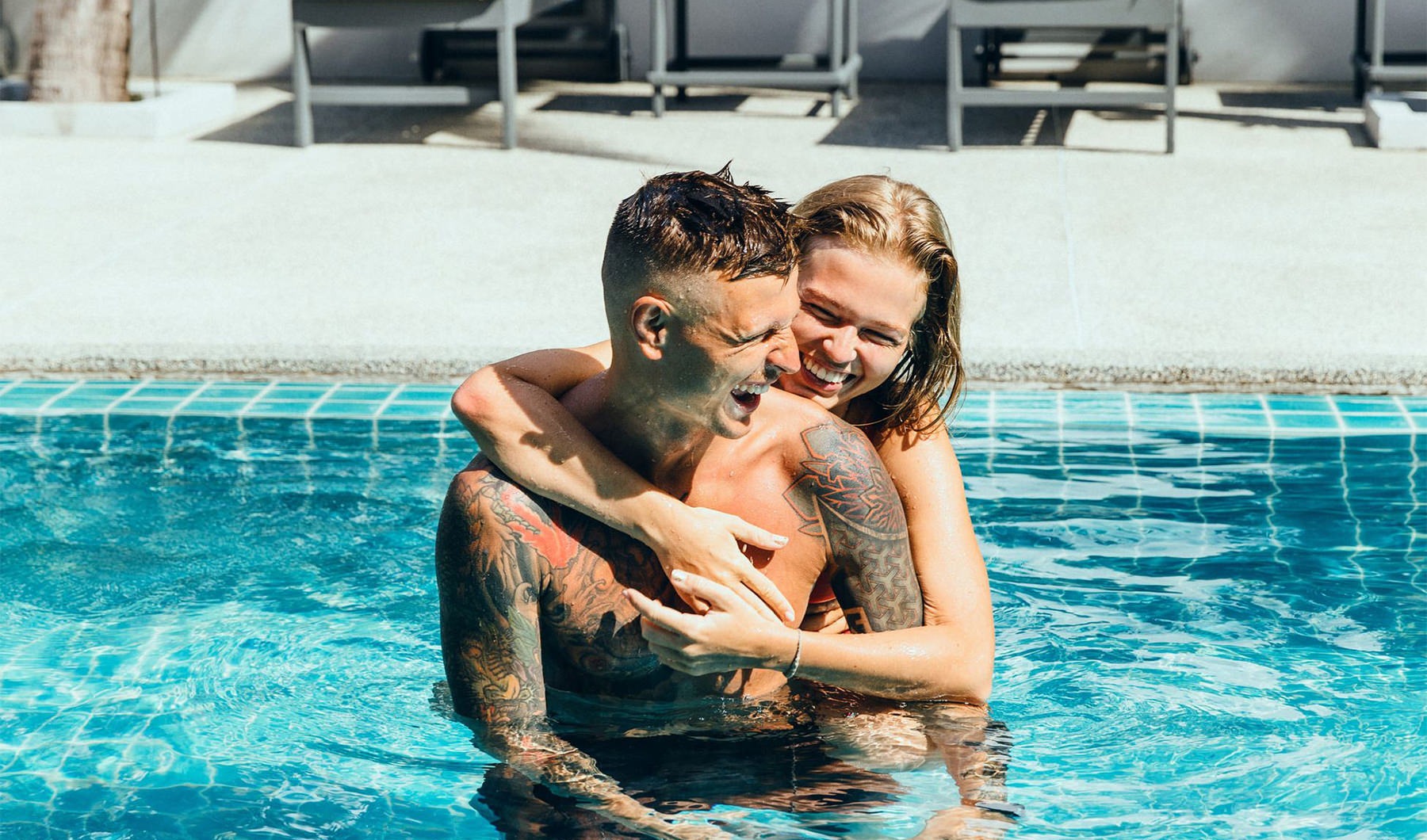 a man and woman hugging in a pool