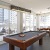 a pool table in a room with large windows